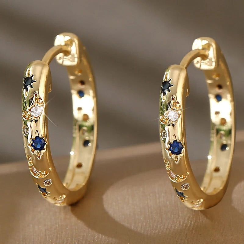Celeste – Eye-catching hoop earrings with moon and star details